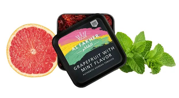 Tarro de Al Fakher Grapefruit Mint junto a rodajas de pomelo y hojas de menta